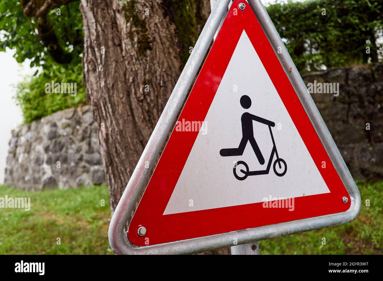 Warning traffic sign - child on scooter alert Stock Photo