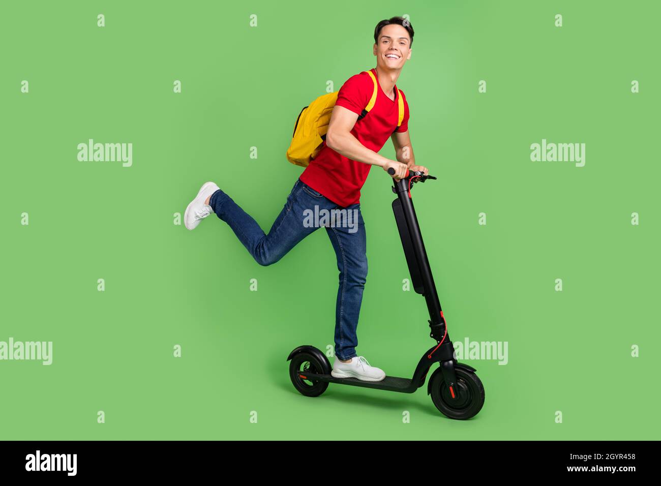 Kick Red Backround Photo of charming funny young guy dressed red t-shirt driving kick ...