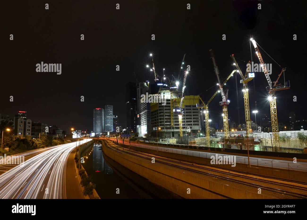 Israel, Tel Aviv, Long exposure Night shot of Ayalon highway with light trails. Azrieli high rises in the background Stock Photo