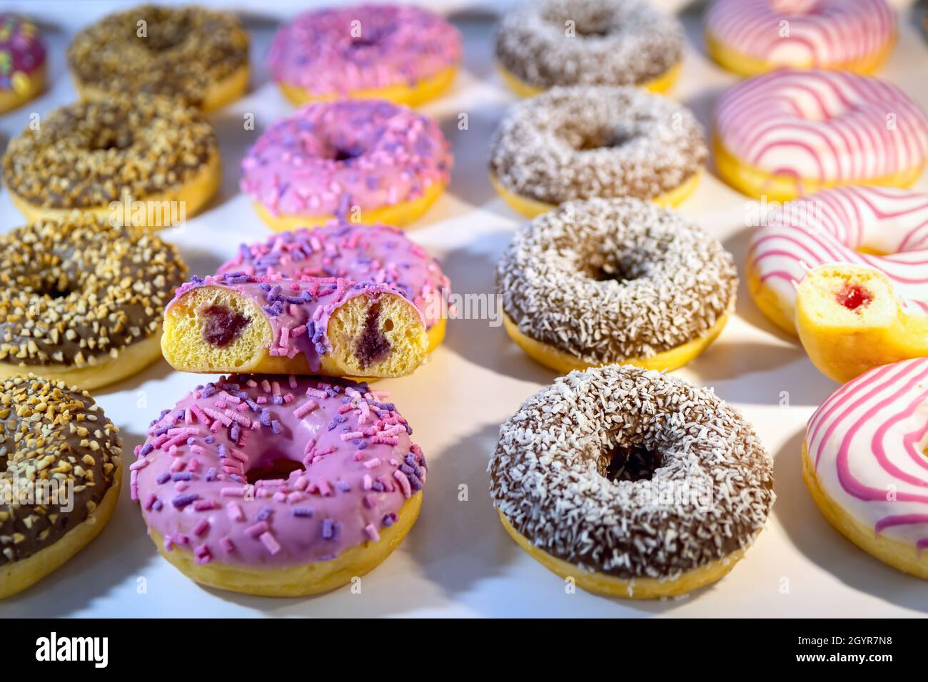Donuts with various fillings and sprinkles top view. Selective focus. Stock Photo
