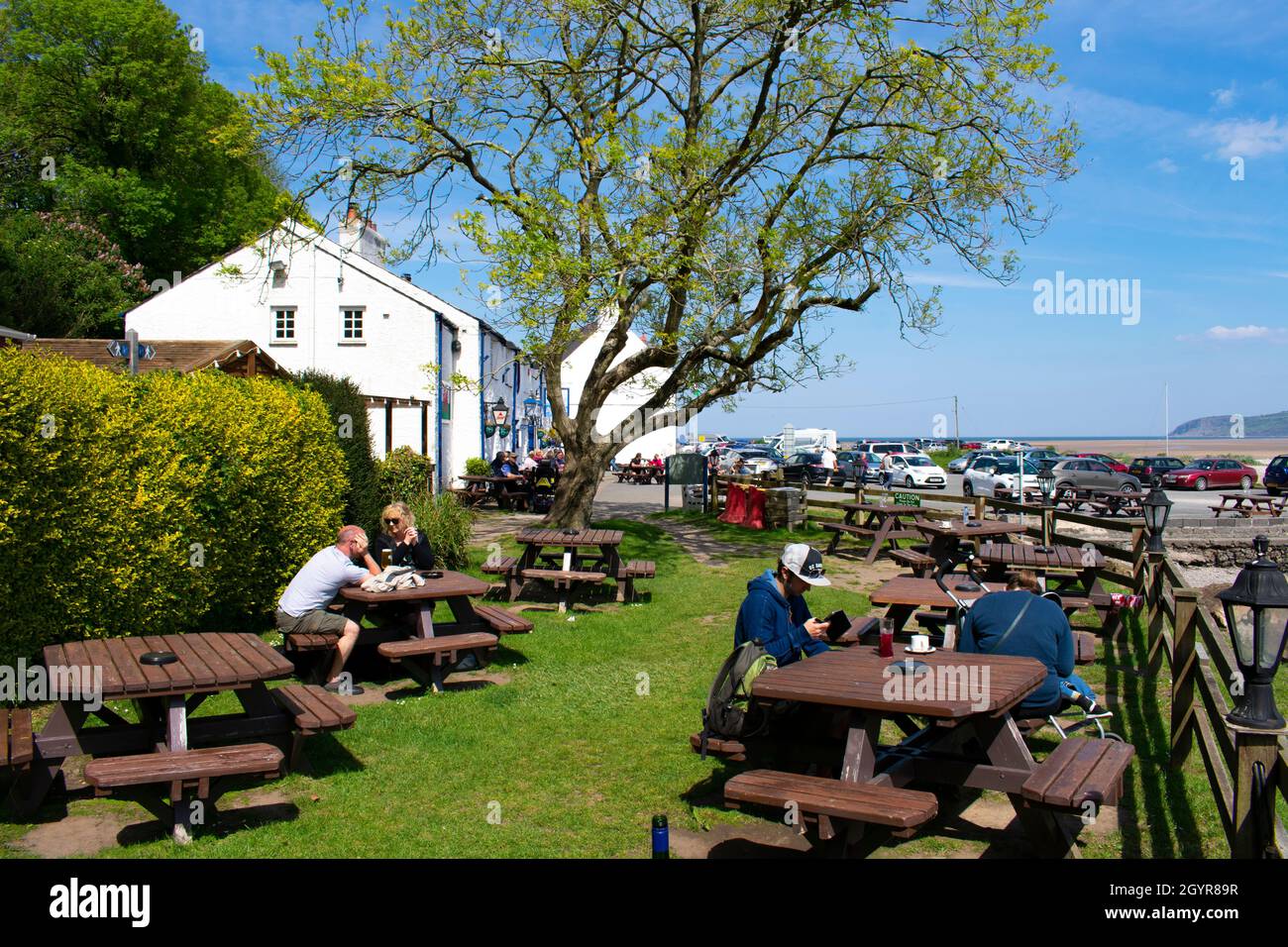 Anglesey - Wales - May 5 2016 : The old, charming Ship Inn at Red Wharf Bay View of the relaxed beer garden with holiday makers sat in the sun Landsca Stock Photo