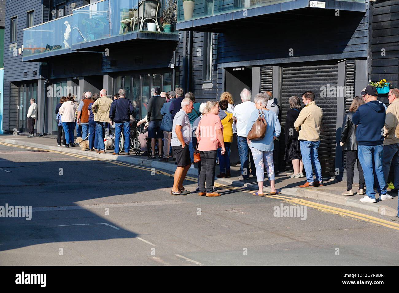 Hastings, East Sussex, UK. 09 October, 2021. Large queues form outside the Hastings Old Town Surgery for the annual flu vaccination wearing face masks. Photo Credit: Paul Lawrenson /Alamy Live News Stock Photo