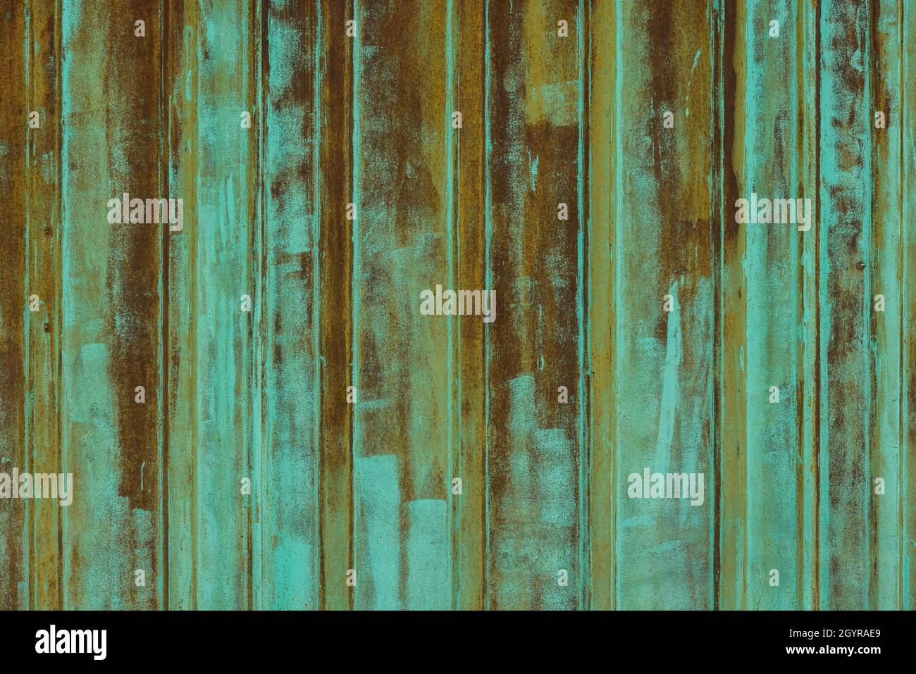 rusted corrugated steel sheet with leftovers of decayed and washed out