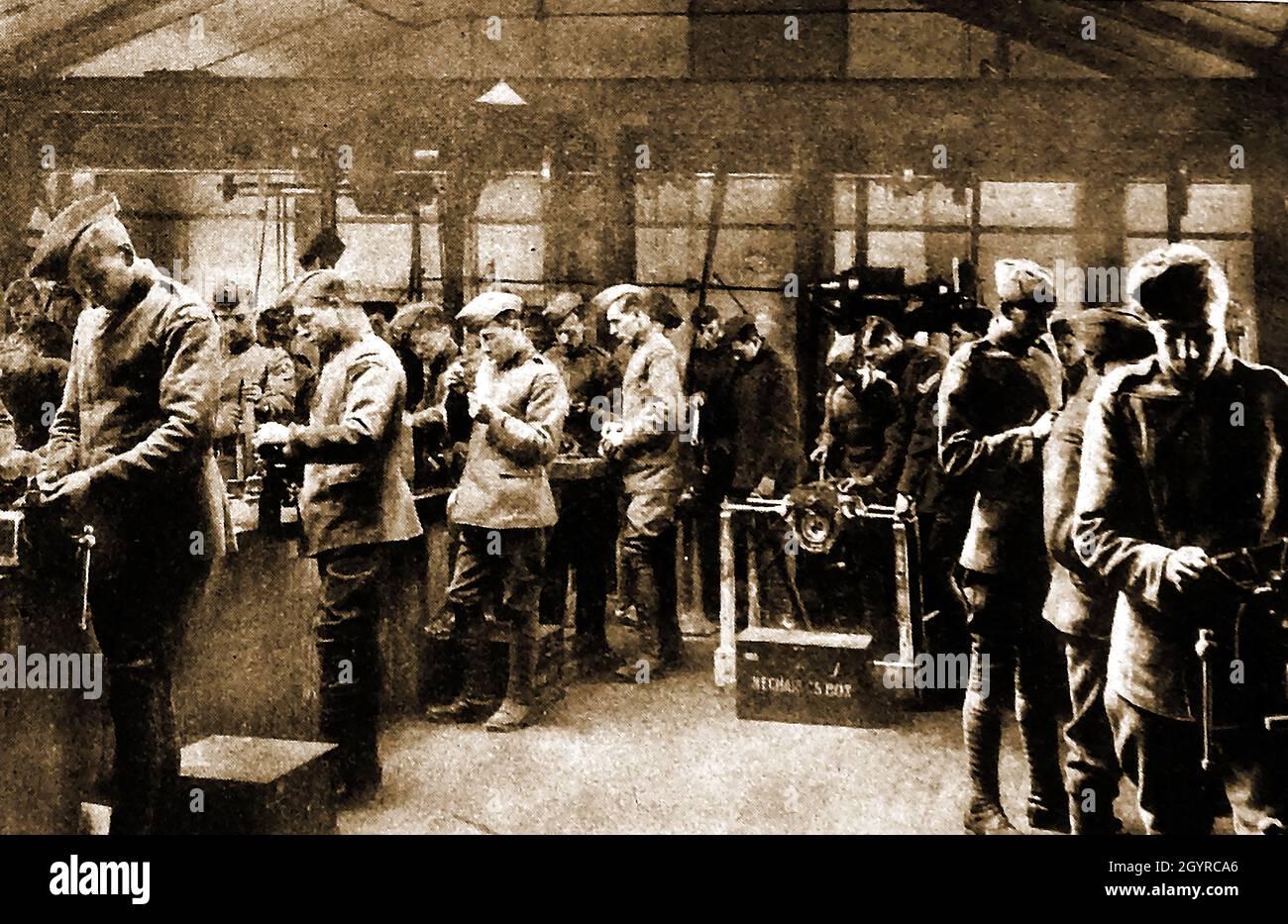 WWI HQ of British Royal Flying Corp - new mechanic recruits in the aeroplane engine erecting shop. Stock Photo