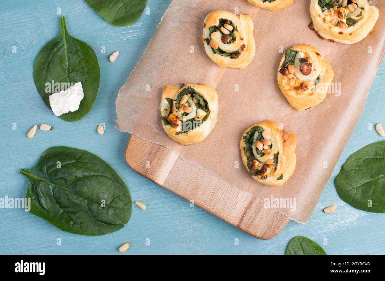Puff pastry with spinach and feta cheese, rolled up to spirals, fresh