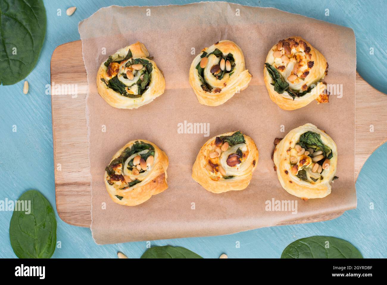 Puff pastry with spinach and feta cheese, rolled up to spirals, fresh