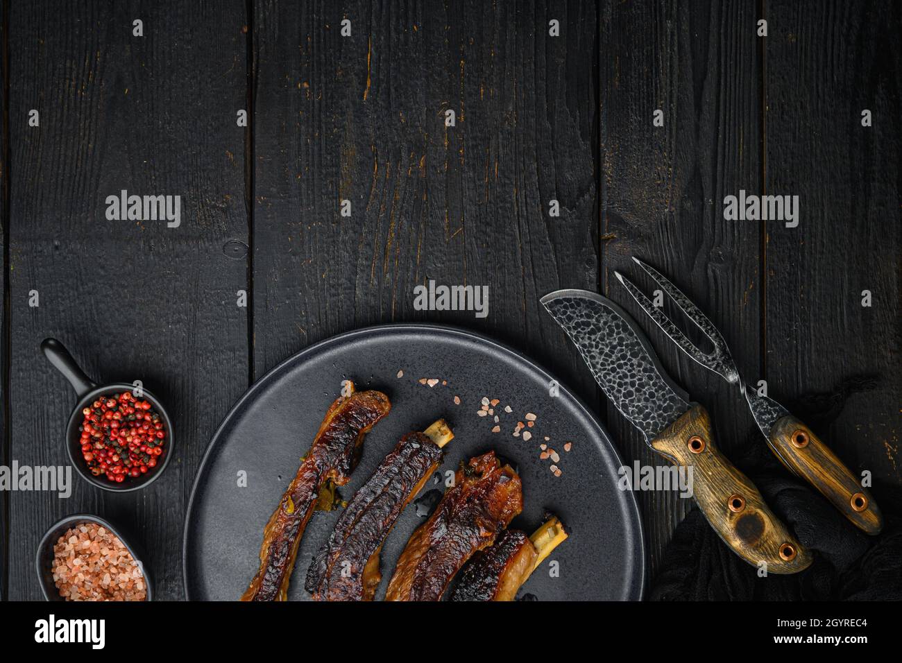 Grilled barbecue pork ribs set, on plate, with barbeque knife and meat ...