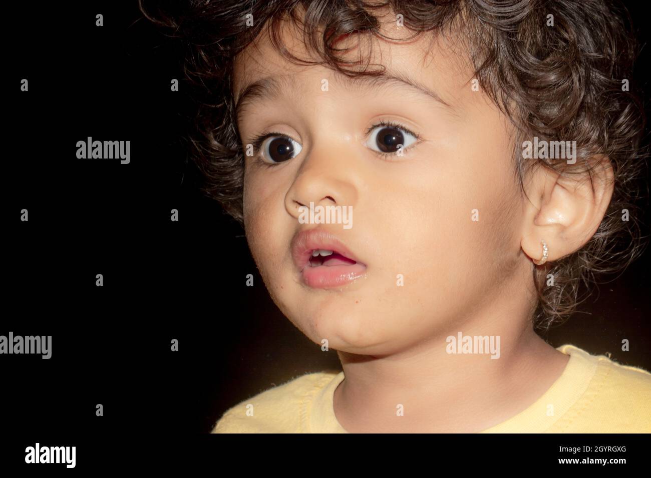 Close up face photo of surprised and sad little indian boy child with black  isolated low key background, india Stock Photo - Alamy