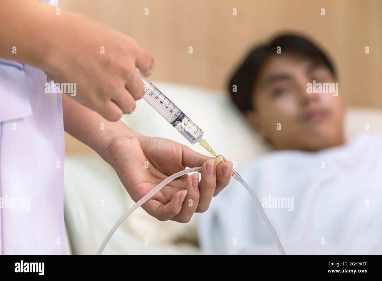 doctor or nurse giving medicine injection to iv tube for patient treatment  at hospital Stock Photo - Alamy