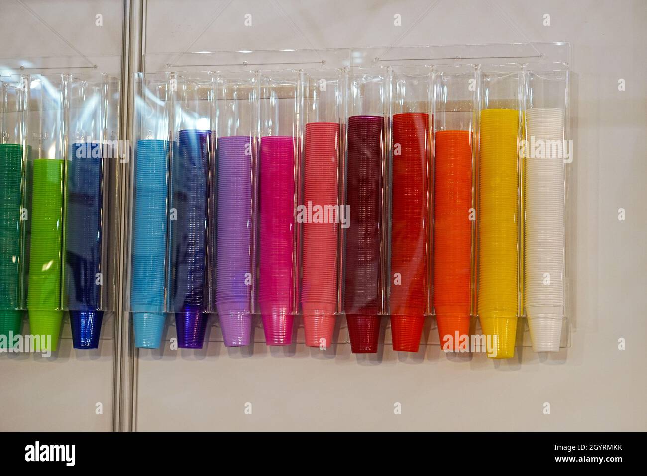 Colorful plastic cups in wall dispenser Stock Photo Alamy