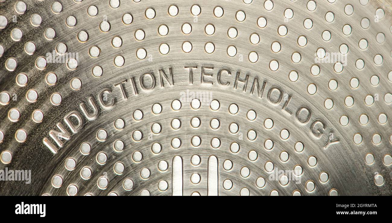 Bottom of induction cookware. Texture of a nonstick induction pan closeup Stock Photo Alamy