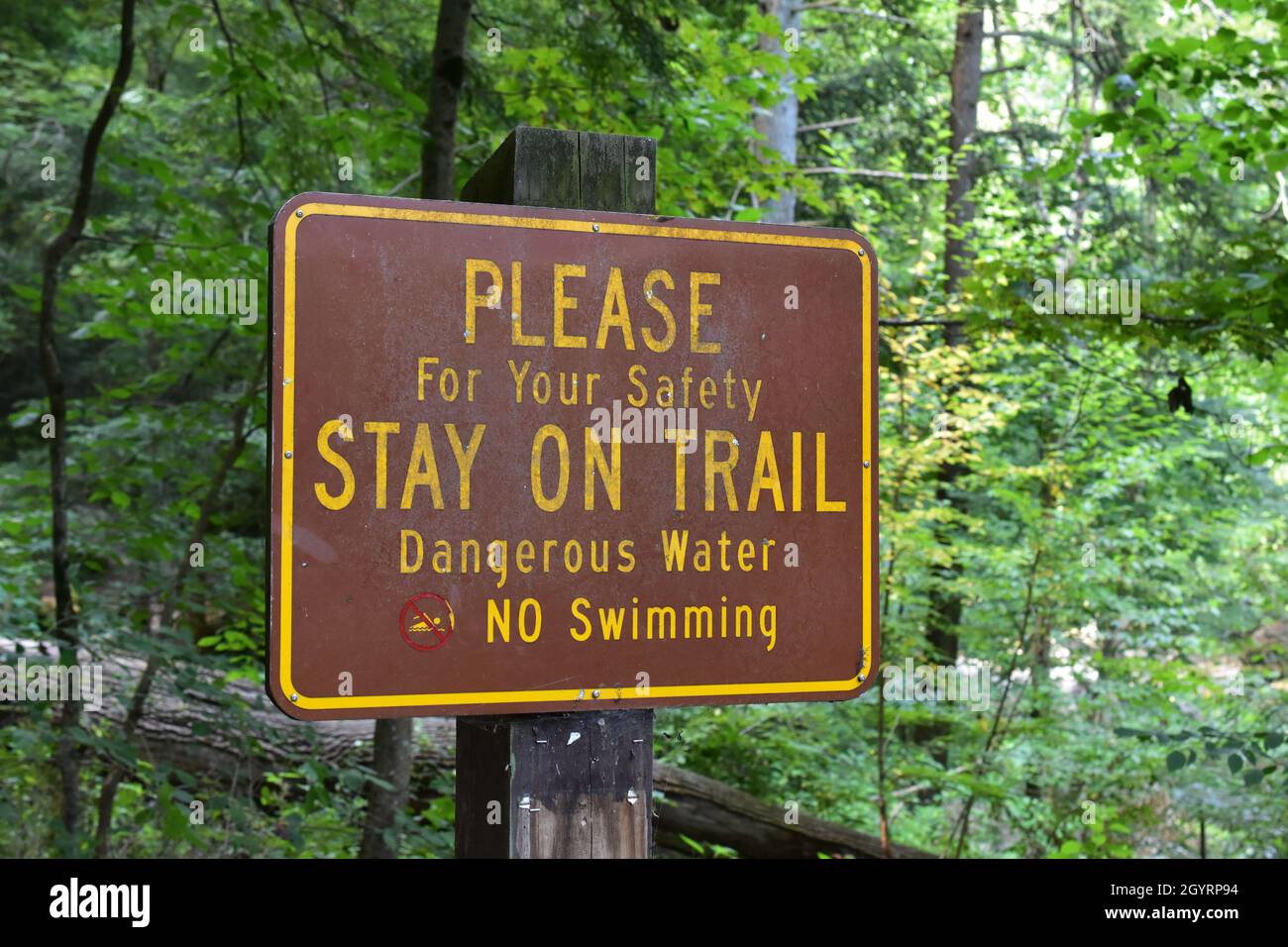 Hiking trail warning sign with dangers Stock Photo Alamy