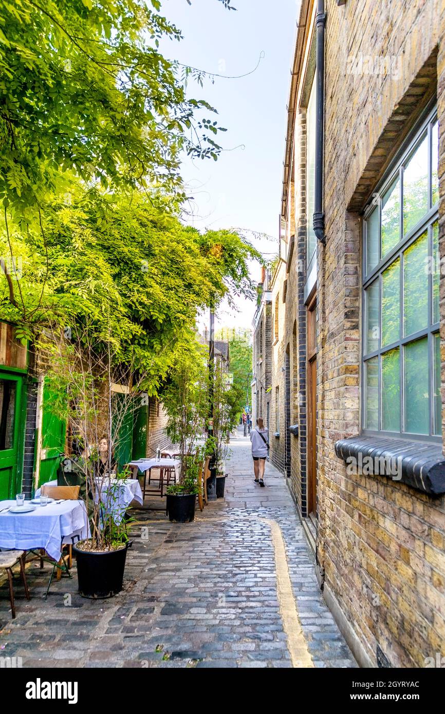 Charming cobblestone alley and Jones Dairy Cafe on Ezra Street, Bethnal Green, London, UK Stock Photo