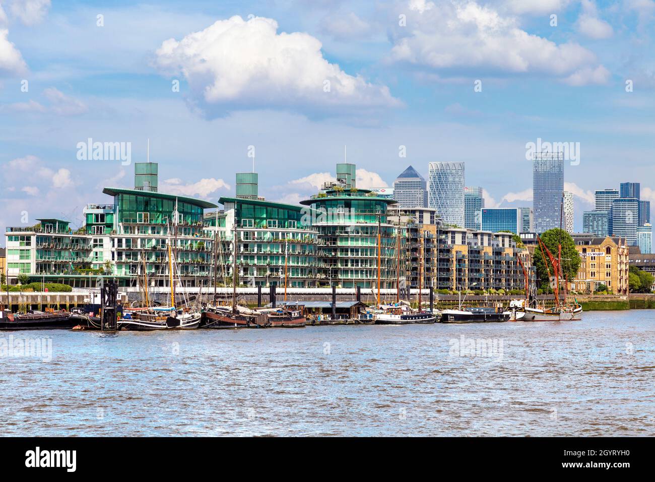 Cinnabar Wharf buildings in Wapping with Canary Wharf in the background as seen from Shad Thames, London, UK Stock Photo