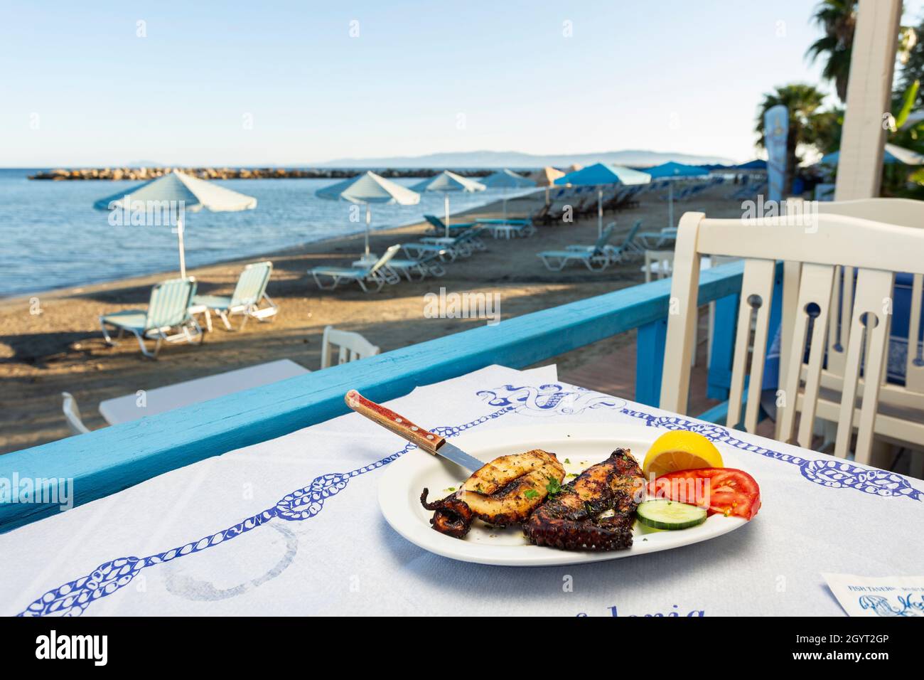 A dish of grilled octopus on the table of a waterfront taverna in Katelios, Kefalonia, Ioanian Islands, Greece Stock Photo