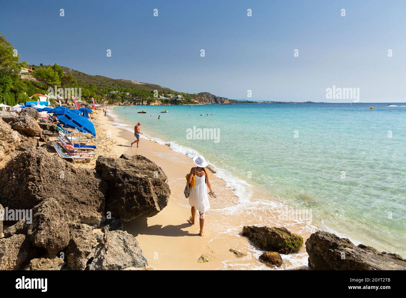A woman walking on Makris Gialos Beach near Argostoli, Kefalonia, Ionian Islands, Greece Stock Photo