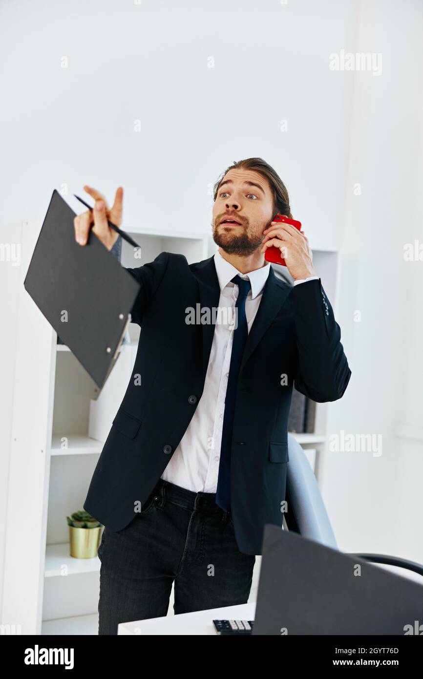 manager holding a phone telephone office technologies Stock Photo - Alamy