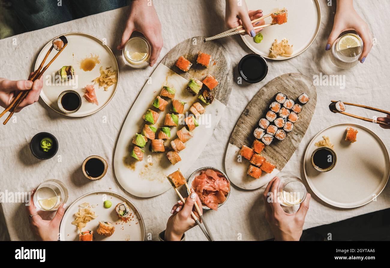 Family or friends having Japanese traditional sushi dinner at quarantine Stock Photo