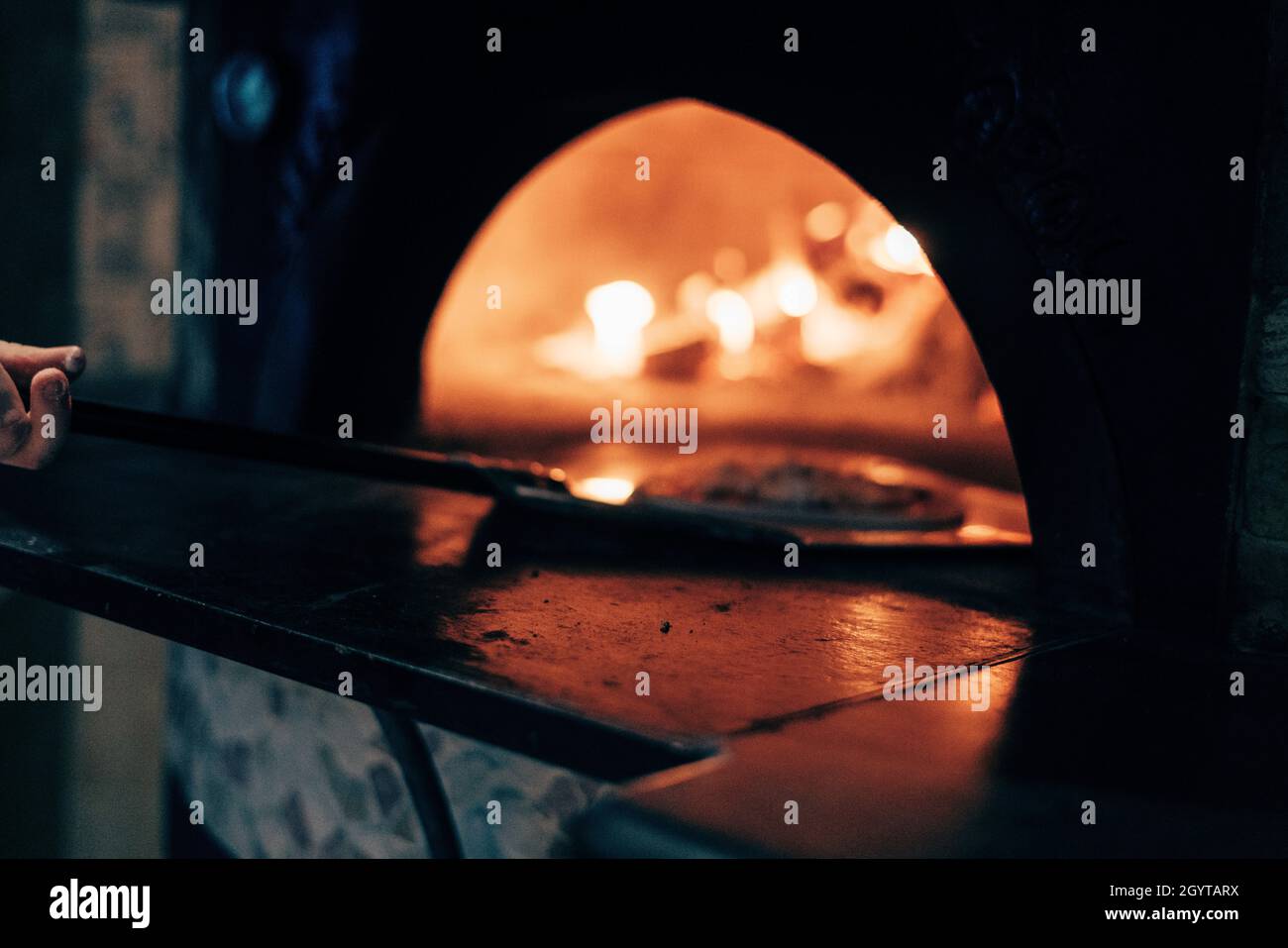 Process of cooking a pizza in a bake on an open fire Stock Photo Alamy
