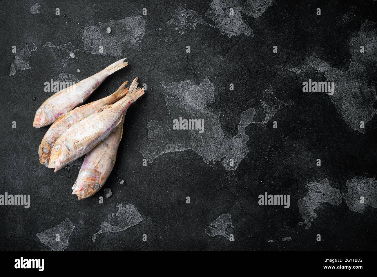 Frozen Goatfish raw fish set, on black dark stone table background, top ...