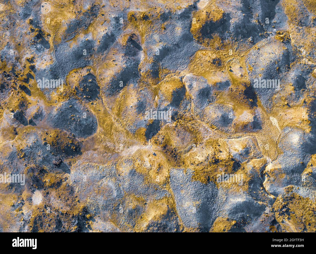 Contaminated surface of spoil heaps from mining at abandoned pyrite mine. Colorful texture, aerial view directly above Stock Photo