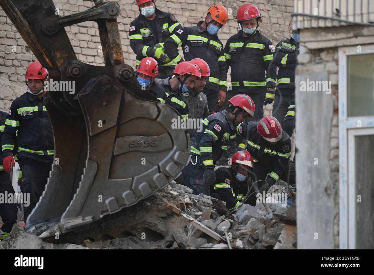 Tbilisi, Georgia. 9th Oct, 2021. Rescuers work on the ruins of a collapsed building in Batumi, Georgia, Oct. 9, 2021. Nine people were killed after a multi-block residential building collapsed in Georgia's Black Sea town of Batumi, the country's interior ministry said on Saturday. The collapse, which happened on Friday, was reportedly caused by violation of construction procedures that had damaged its retaining wall. Credit: Kulumbegashvili Tamuna/Xinhua/Alamy Live News Stock Photo
