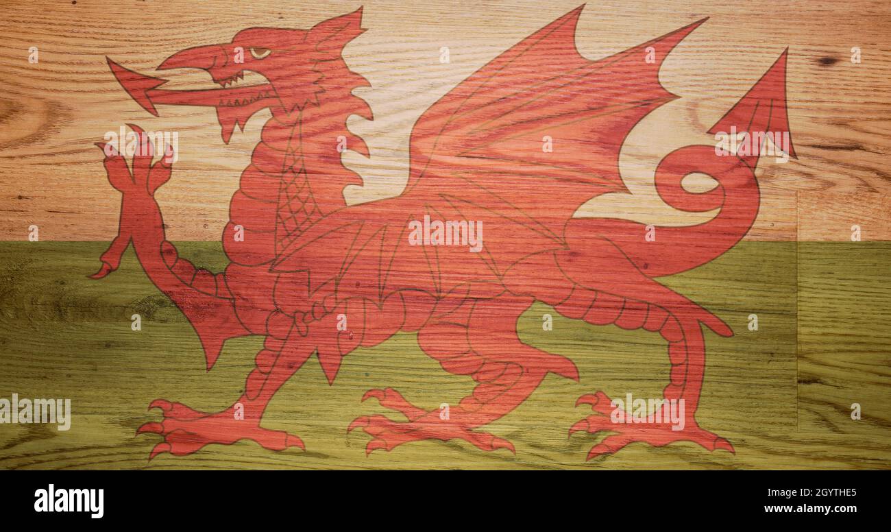 Symbolic Welsh Dragon flag transluscent laid over a wooden background Stock Photo