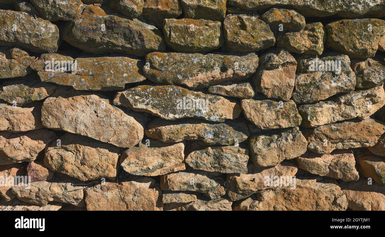 detail of an unmortared wall made of natural stone Stock Photo
