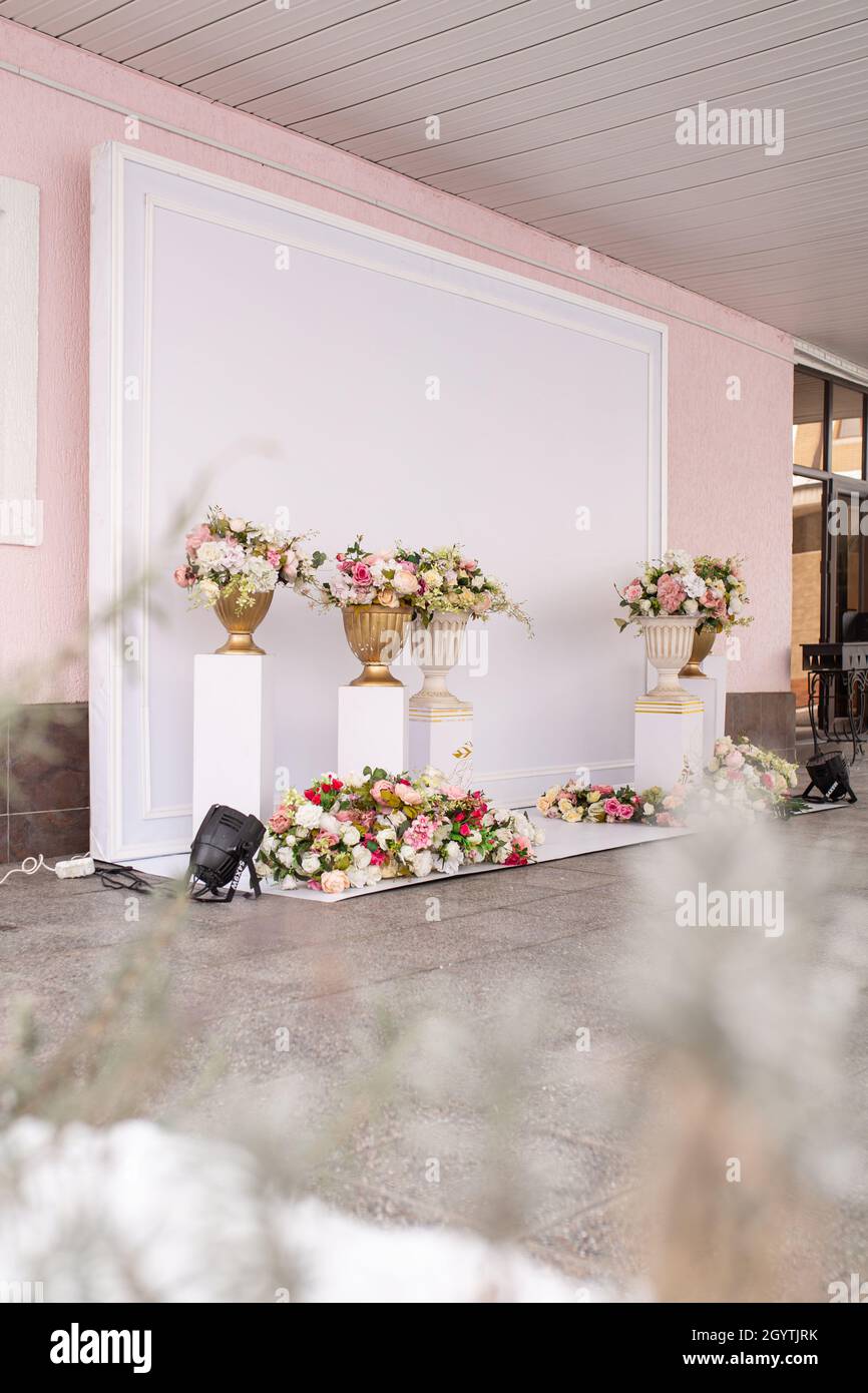 White photo zone with columns of flowers. Stock Photo