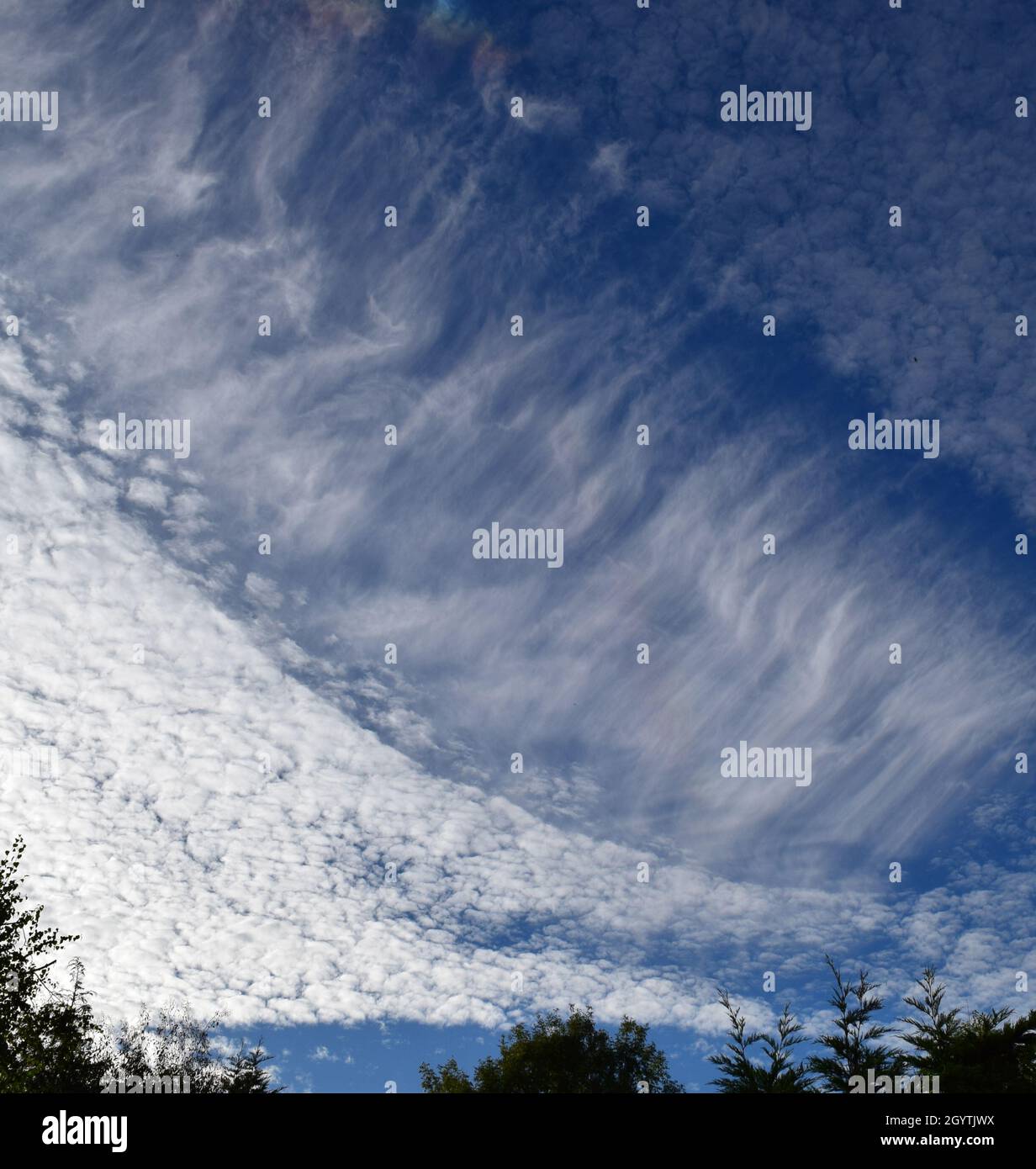 Distinctive lines of Cirrus cloud grace the skies Stock Photo