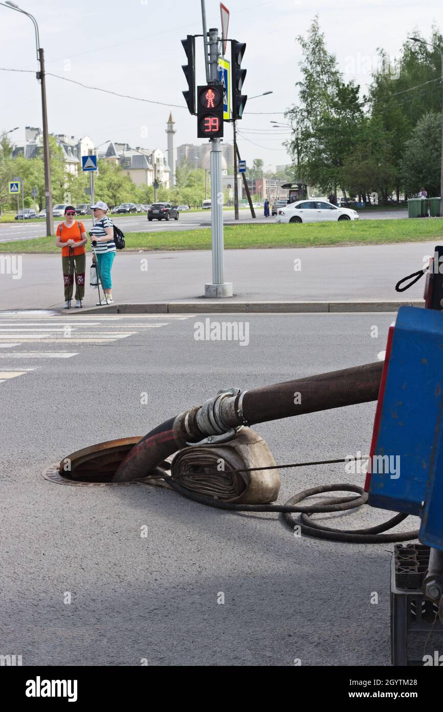 Cleaning the sewer system after flooding Parashyutnaya street in St. Petersburg Stock Photo