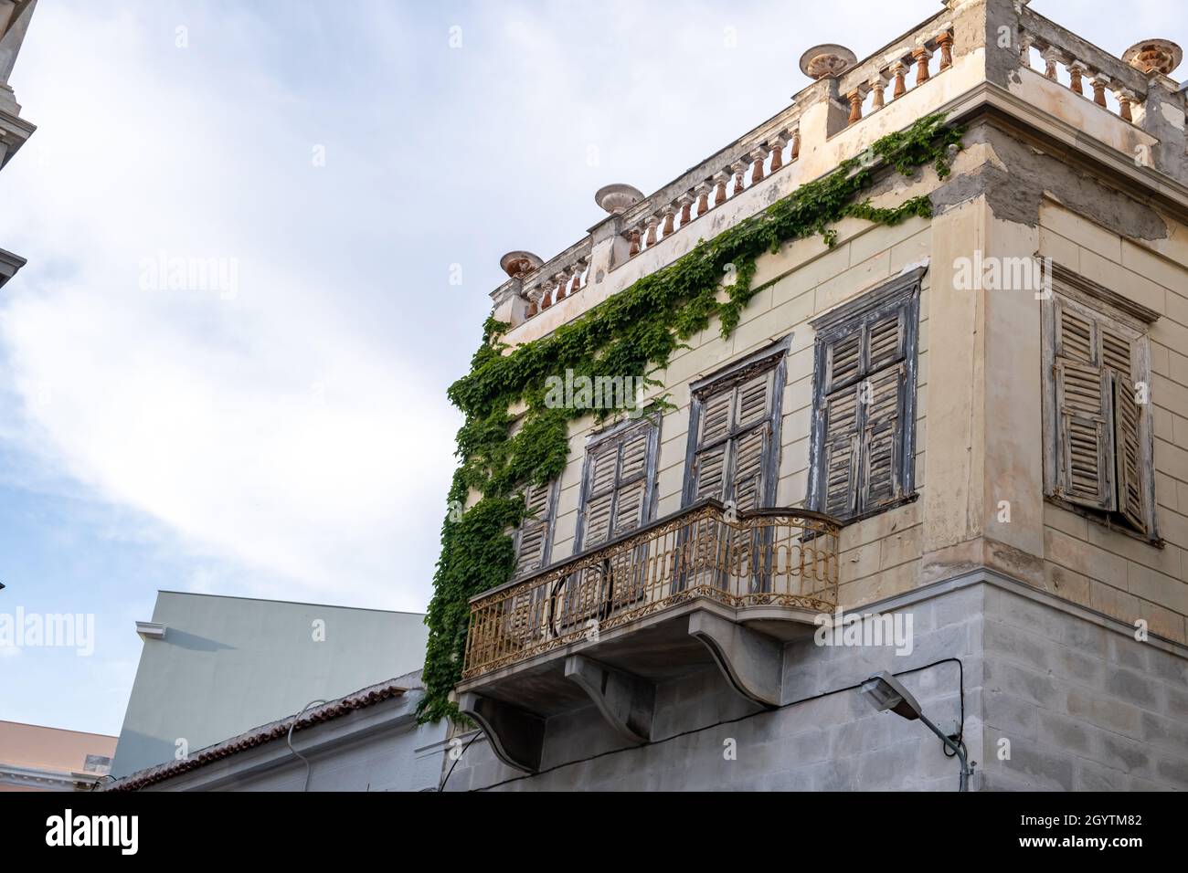 Syros island, Cyclades, destination Greece. Bellow to upper view of old construction building at capital of Siros Hermoupolis. House with marble walls Stock Photo