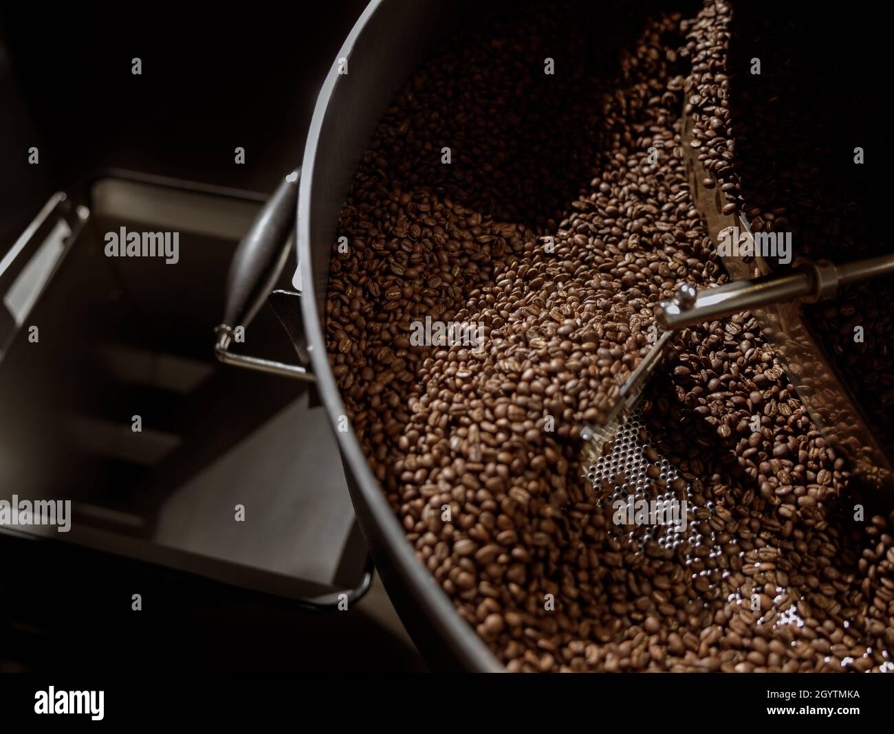 Coffee beans in cooling tray of coffee roasting machine Stock Photo - Alamy
