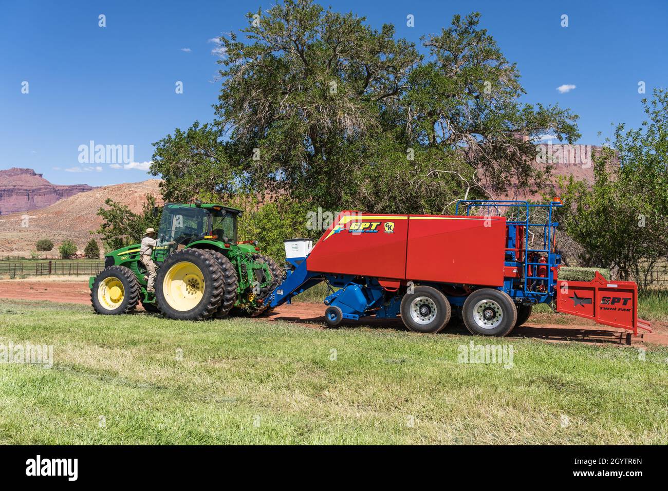Baling hay with a John Deere 7930 tractor and a GPT Twin Pak baler on a