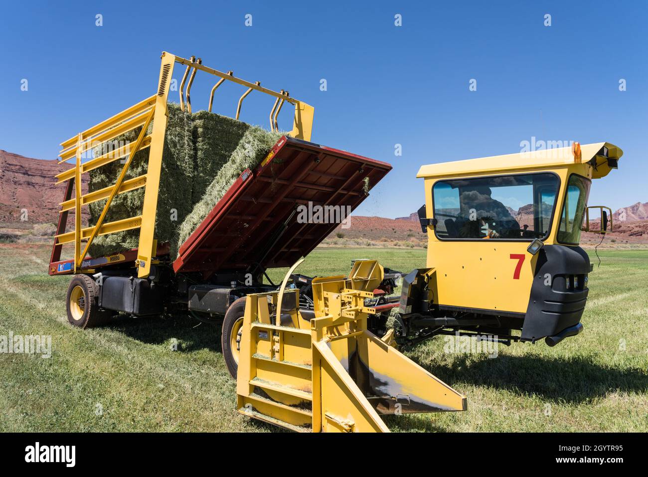 An automatic bale wagon or stack wagon stacks hay bales in the wagon with a  hydraulic lift table Stock Photo - Alamy