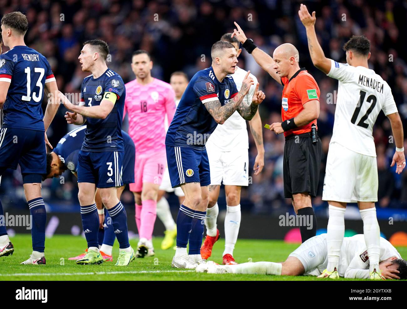 Scotland's Lyndon Dykes speaks to referee Szymon Marciniak after his goal is disallowed, before the decision is later overturned by VAR during the FIFA World Cup Qualifying match at Hampden Park, Glasgow. Picture date: Saturday October 9, 2021. Stock Photo