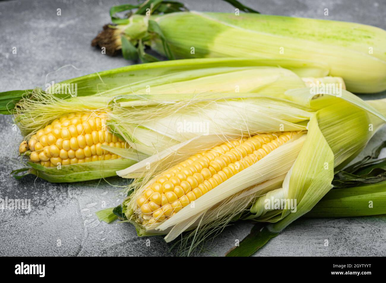 Fresh ripe corn cobs set, on gray stone table background Stock Photo ...