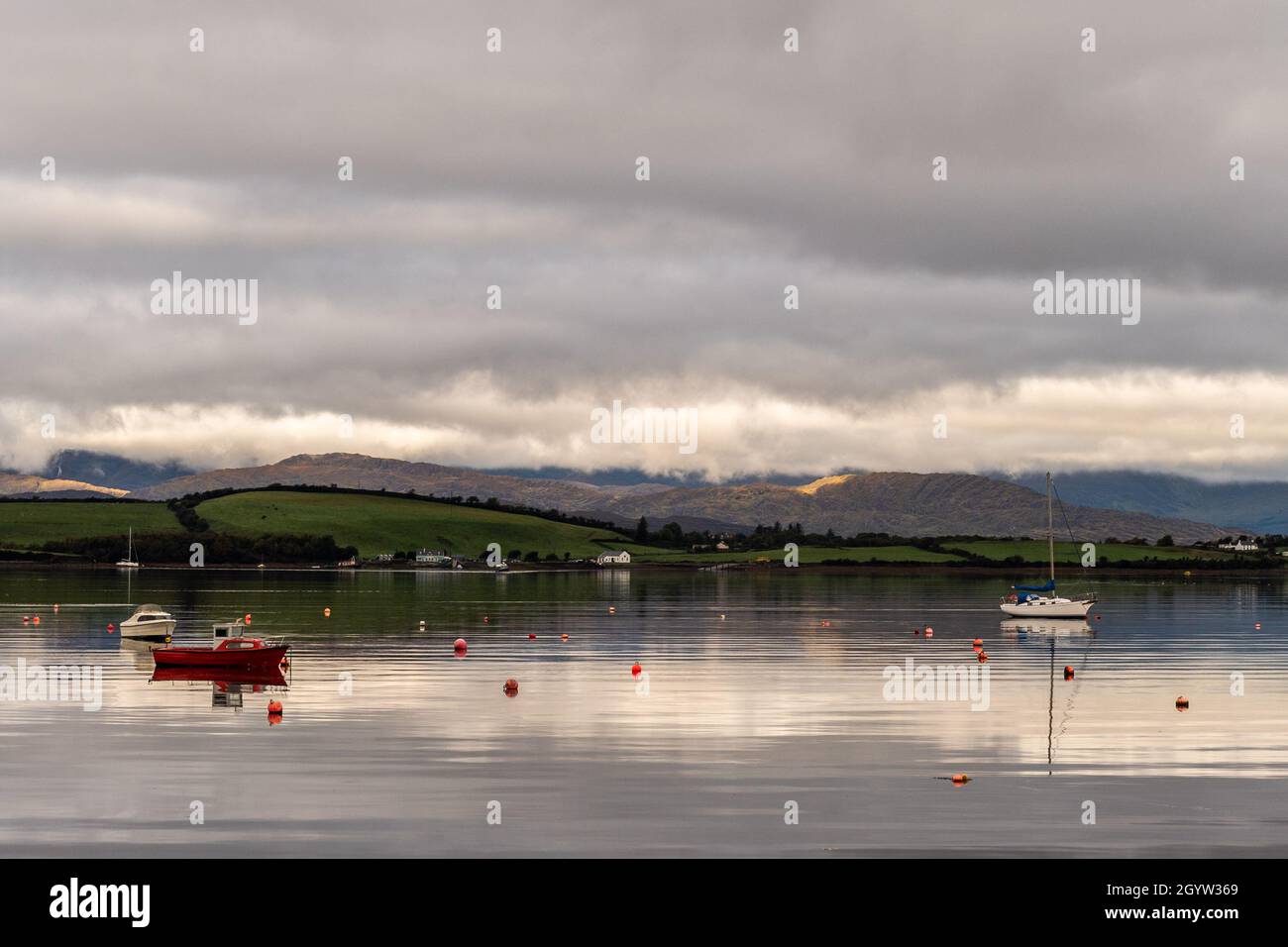 Bantry, West Cork, Ireland. 9th Oct, 2021. There was a flat calm in Bantry Bay today, with low cloud cover over Whiddy Island. Credit: AG News/Alamy Live News Stock Photo