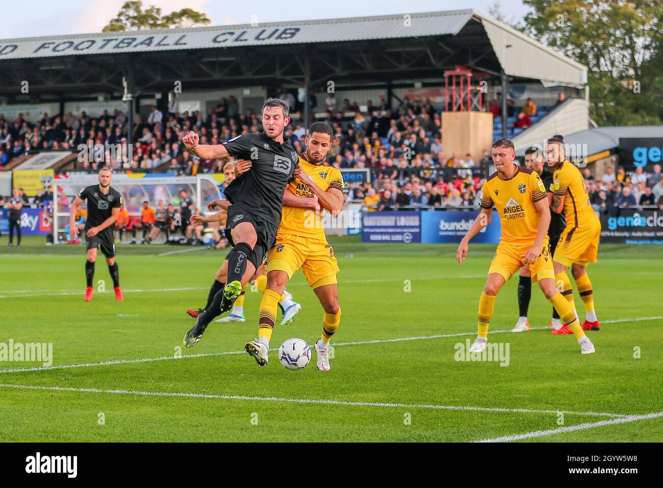 VBS Community Stadium, Sutton, London. 9th Oct, 2021. EFL League 2 football, Sutton United versus Port Vale; Ben Garrity (8) of Port Vale ahead of Jonathan Barden (2) of Sutton United Credit: Action Plus Sports/Alamy Live News Stock Photo