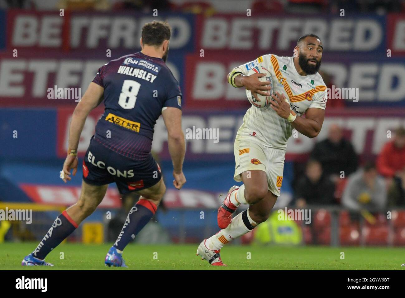 Samisoni Langi (3) of Catalans Dragons looks to run past Alex Walmsley ...