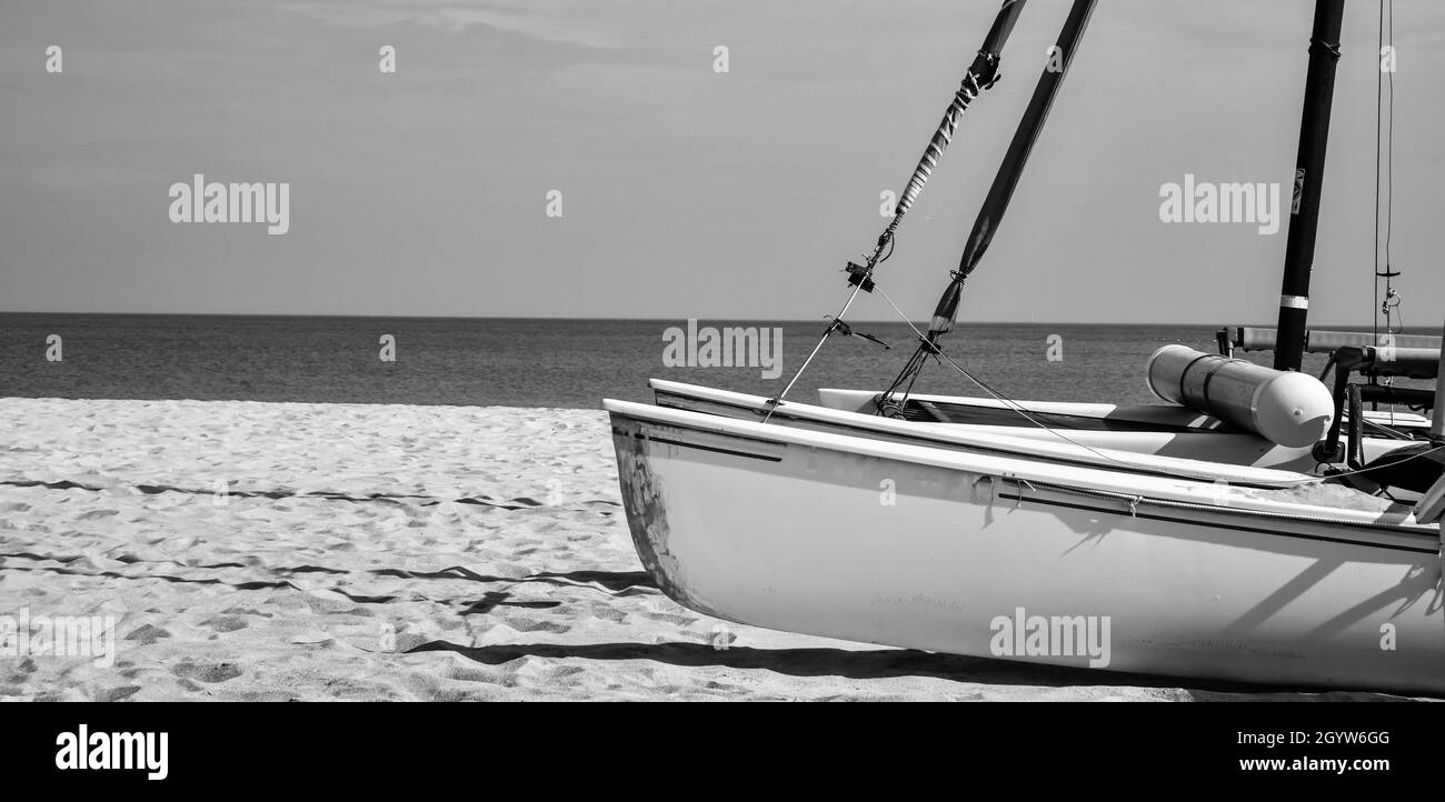 Catamaran sailboats stored on the beach after summer Stock Photo