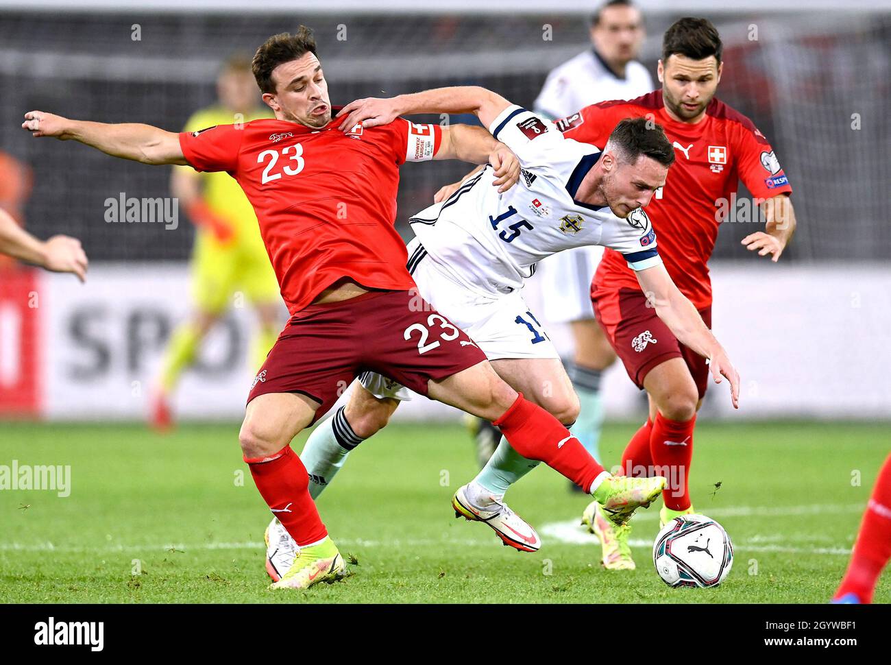 Switzerland's Xherdan Shaqiri (left) and Northern Ireland's Jordan Thompson battle for the ball during the FIFA World Cup Qualifying match at Stade de Geneve, Switzerland. Picture date: Saturday October 9, 2021. Stock Photo