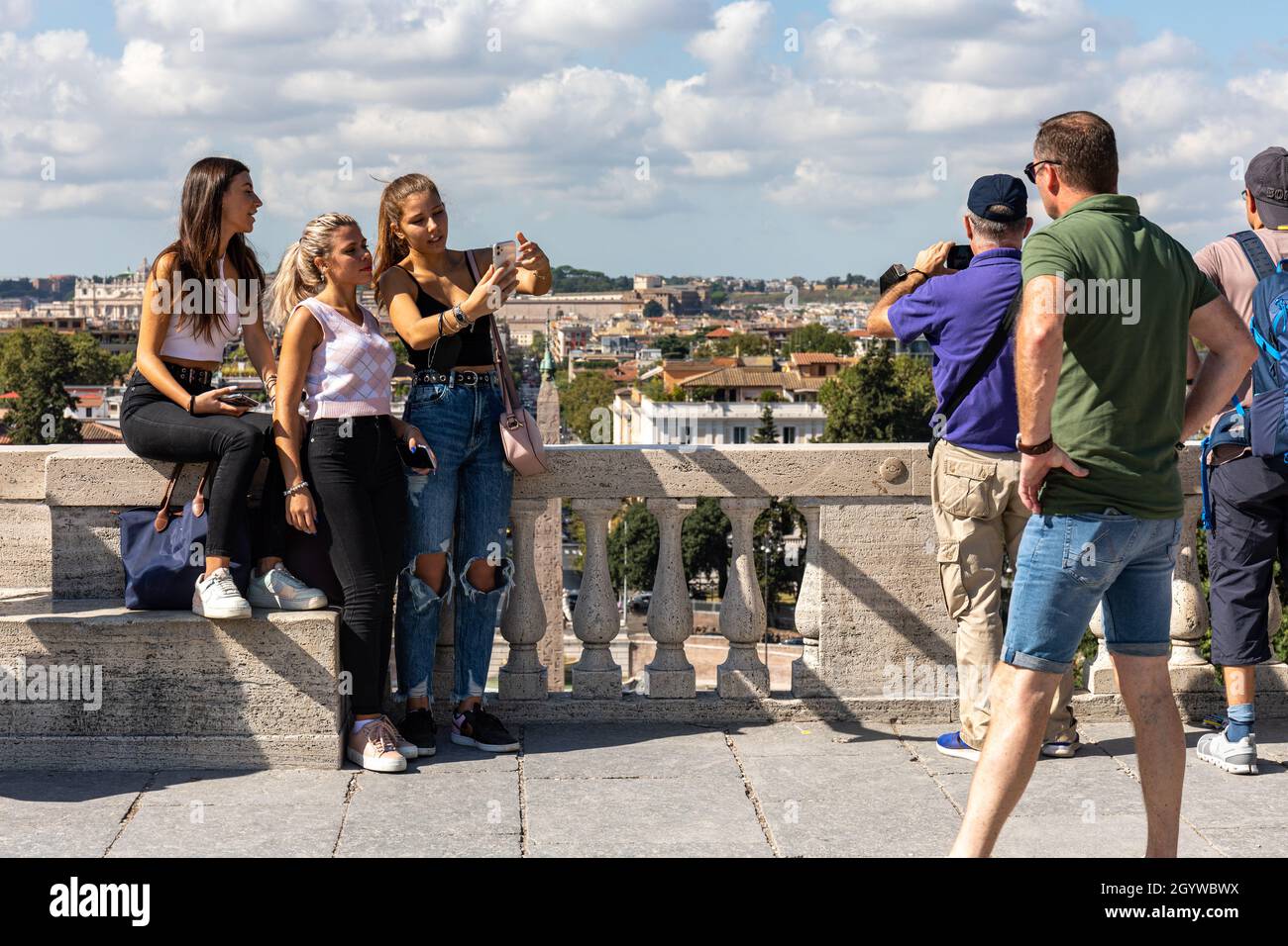 Young women or teenage girls taking a group selfie on Terrazza del Pincio in Rome, Italy Stock Photo