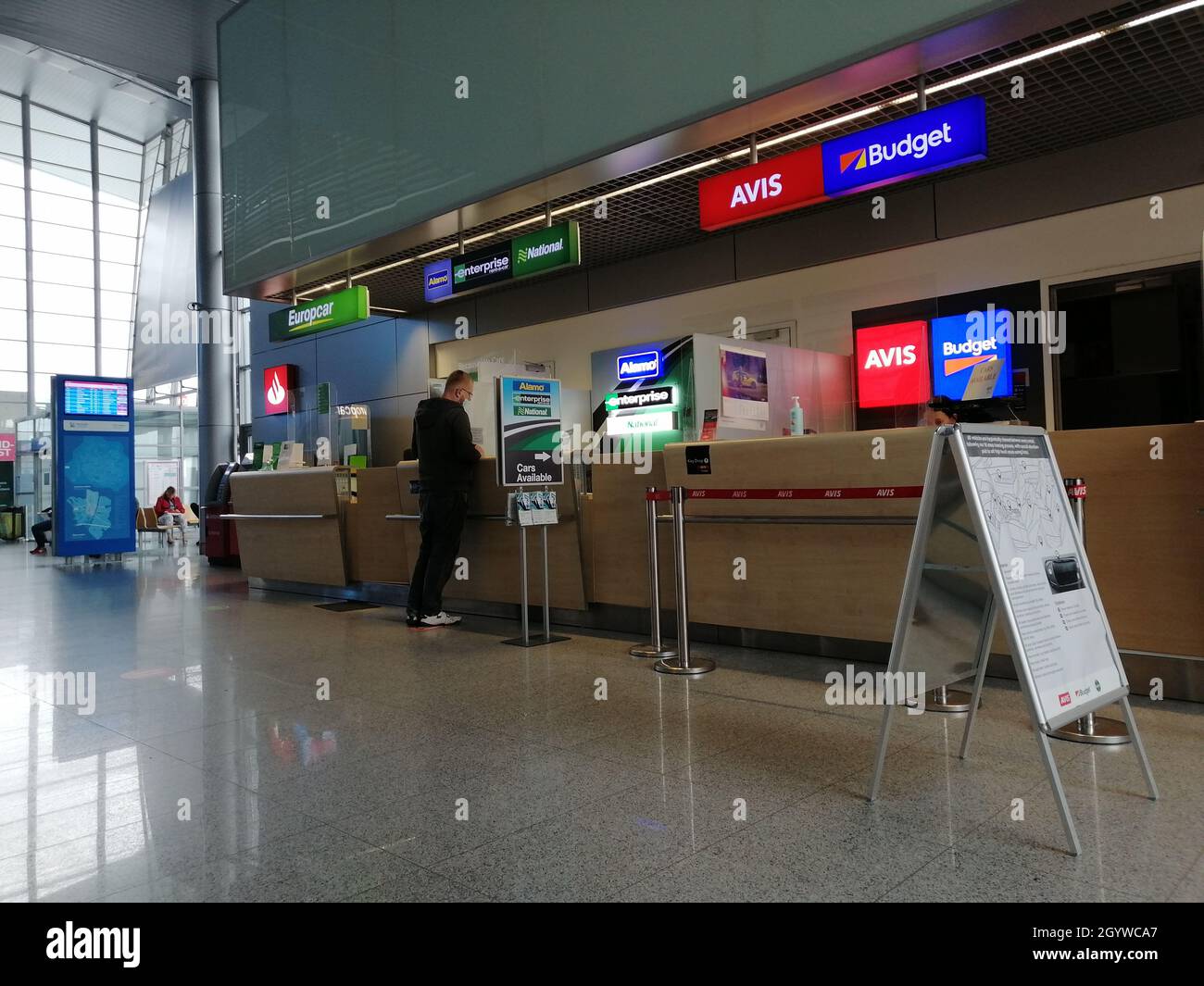 POZNAN, POLAND Sep 17, 2021 A person standing by a car rental desk
