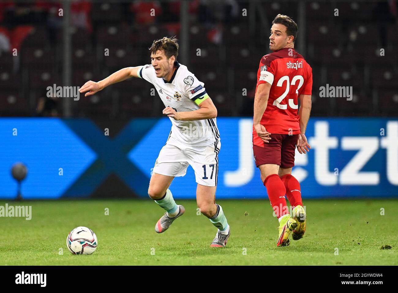 Northern Ireland’s Paddy McNair and Switzerland’s Xherdan Shaqiri during the FIFA World Cup Qualifying match at Stade de Geneve, Switzerland. Picture date: Saturday October 9, 2021. Stock Photo