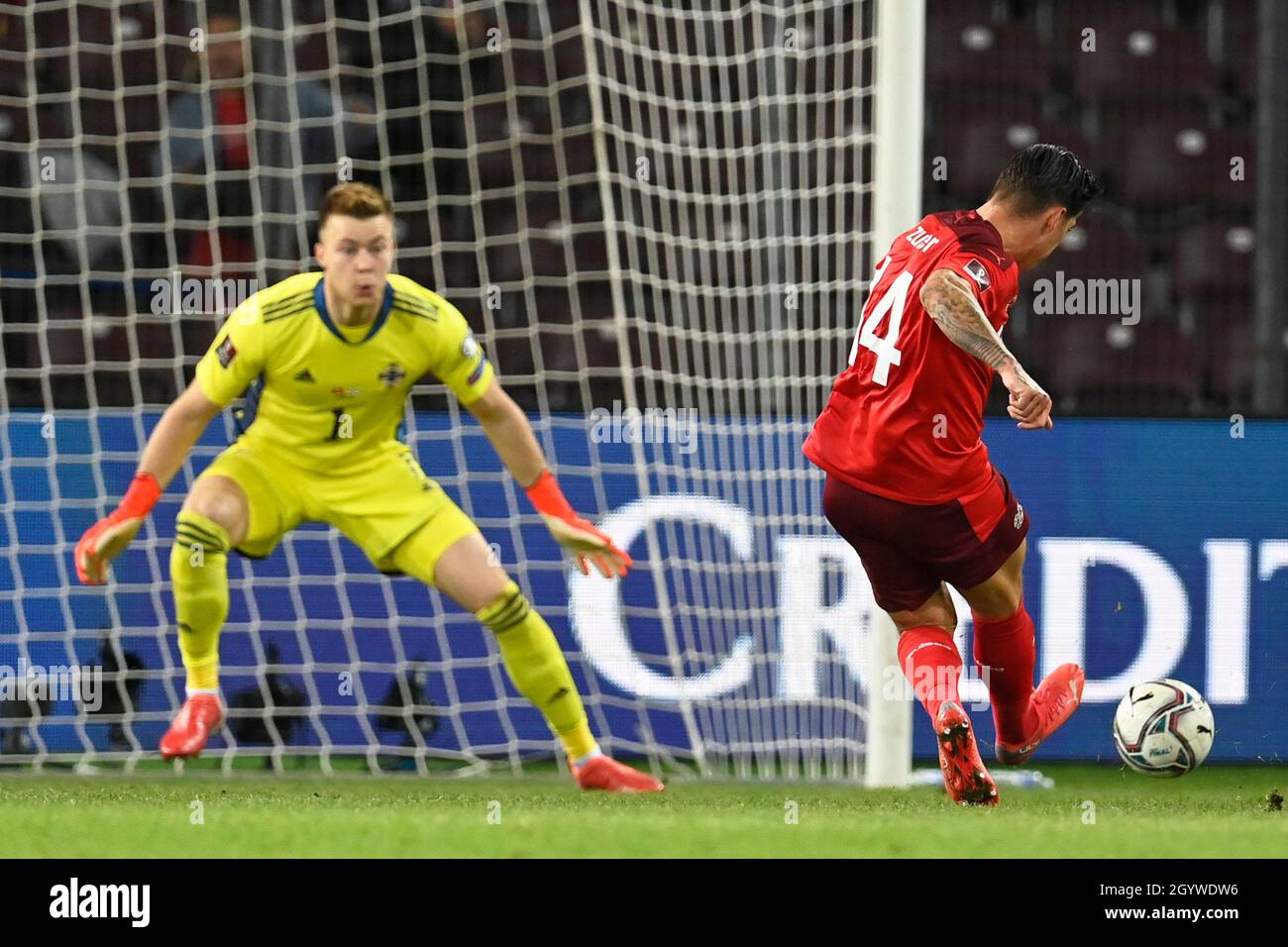 Switzerland’s Steven Zuber scores their side's first goal of the game past Northern Ireland goalkeeper Bailey Peacock-Farrell during the FIFA World Cup Qualifying match at Stade de Geneve, Switzerland. Picture date: Saturday October 9, 2021. Stock Photo