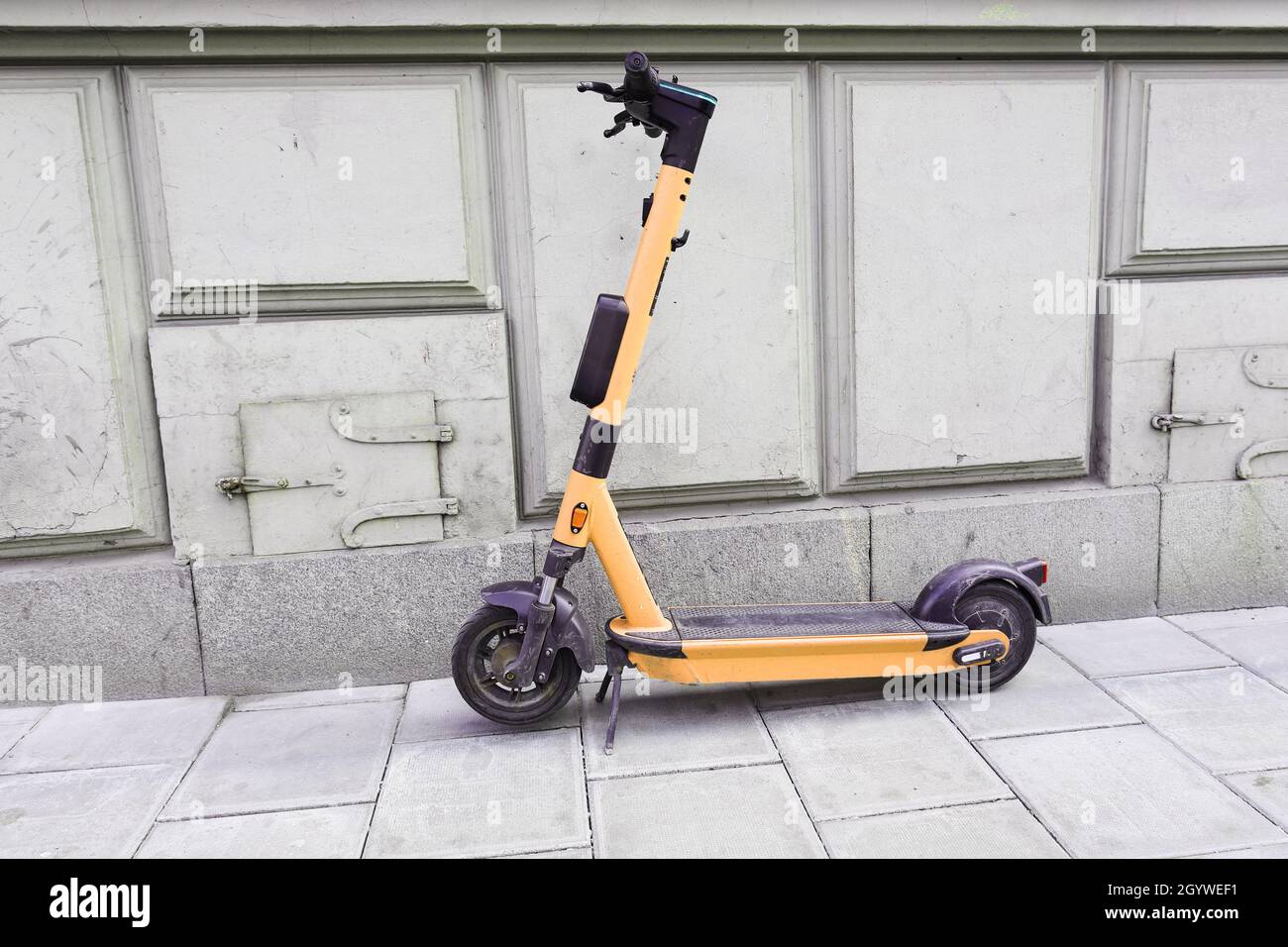 Electric push scooter parked on the sidewalk Stock Photo Alamy