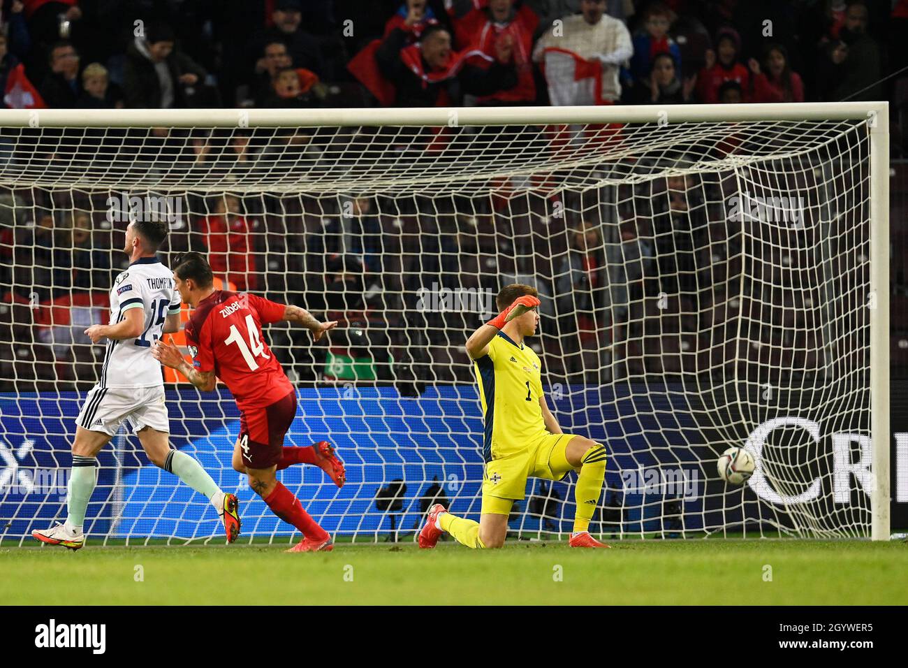 Switzerland’s Steven Zuber scores their side's first goal of the game past Northern Ireland goalkeeper Bailey Peacock-Farrell during the FIFA World Cup Qualifying match at Stade de Geneve, Switzerland. Picture date: Saturday October 9, 2021. Stock Photo