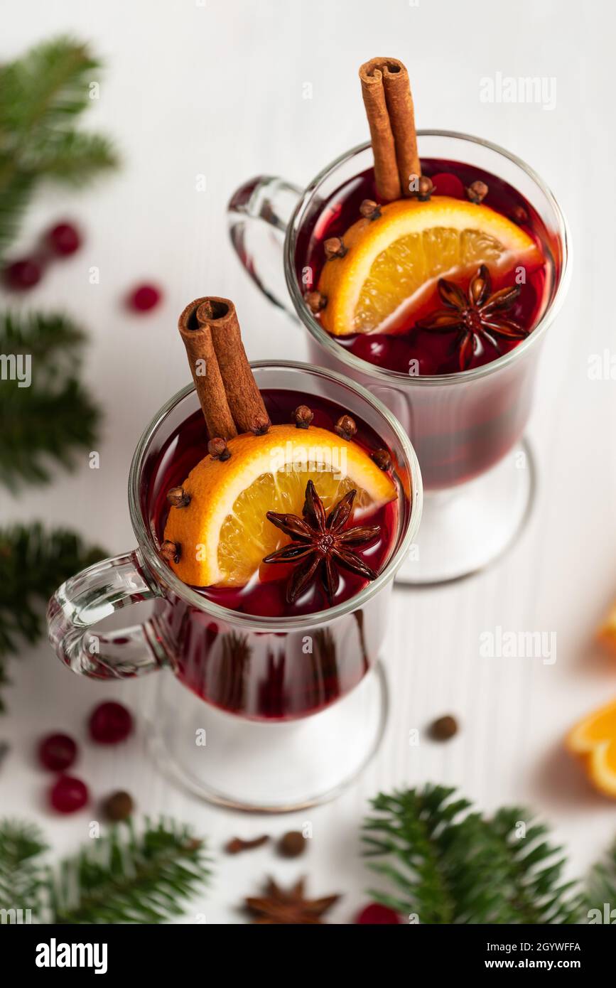 Mulled wine in glasses on a white background near Christmas tree Stock Photo