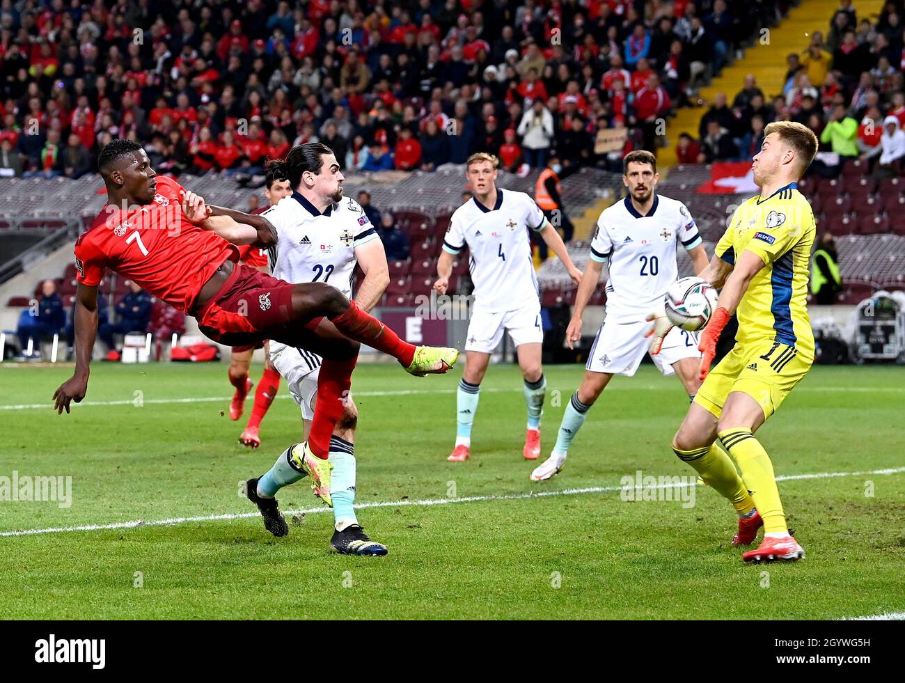 Northern Ireland goalkeeper Bailey Peacock-Farrell (right) saves a shot from Switzerland's Breel Embolo during the FIFA World Cup Qualifying match at Stade de Geneve, Switzerland. Picture date: Saturday October 9, 2021. Stock Photo